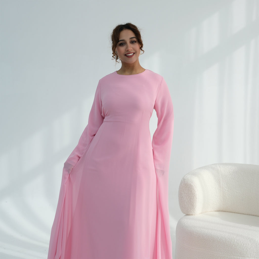 Woman wearing a pink dress against a white background