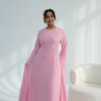 Woman wearing a pink dress against a white background