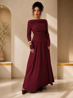 Woman wearing a burgundy evening gown in an elegant indoor setting