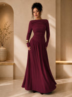 Woman wearing a burgundy evening gown in an elegant indoor setting