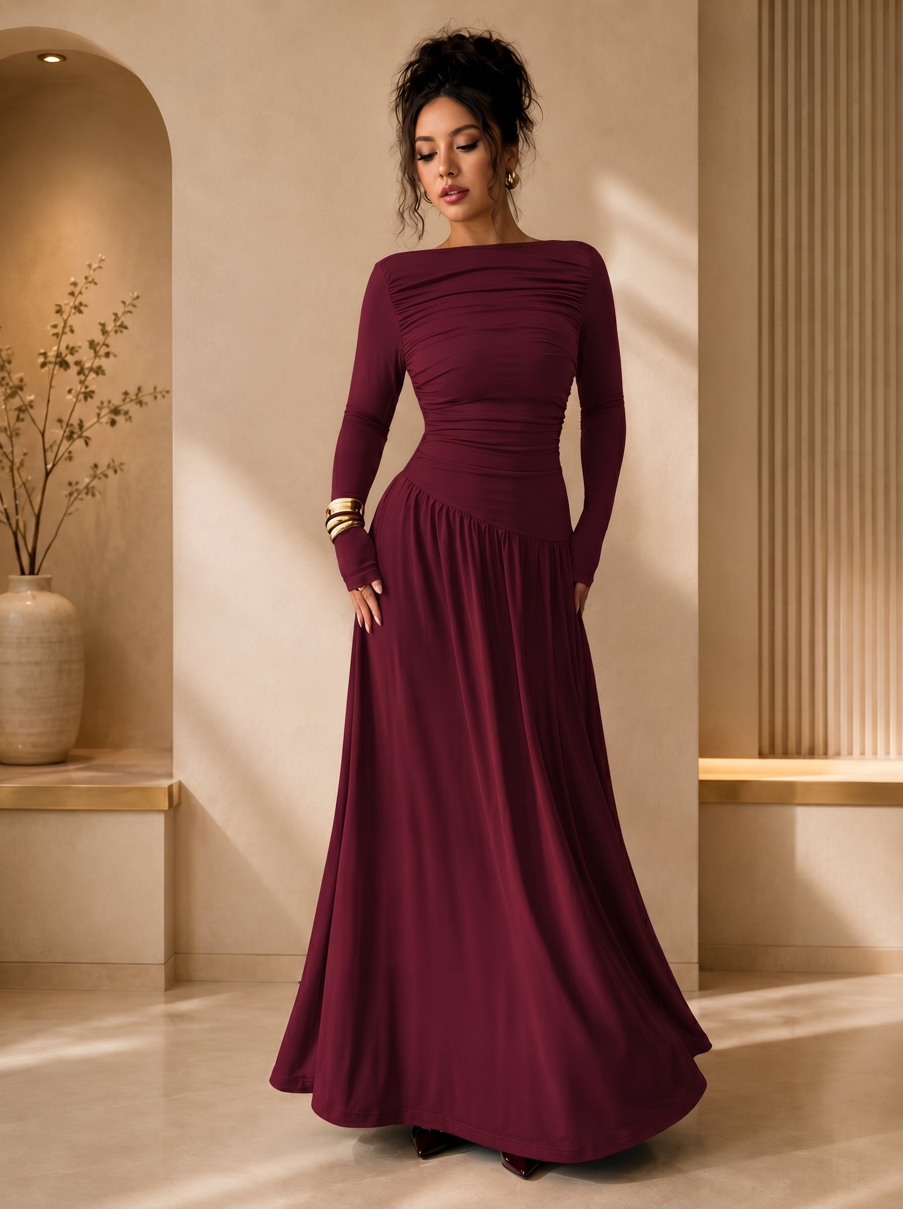Woman wearing a burgundy evening gown in an elegant indoor setting
