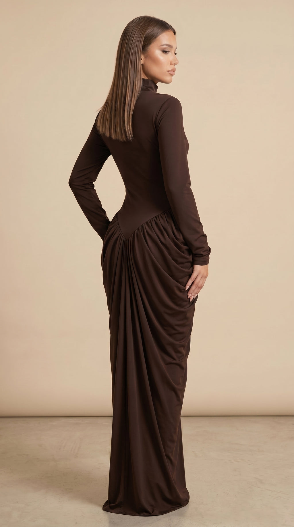Woman wearing a brown long-sleeve dress with a draped effect on a beige background
