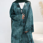 Green robe worn by a person on a white background