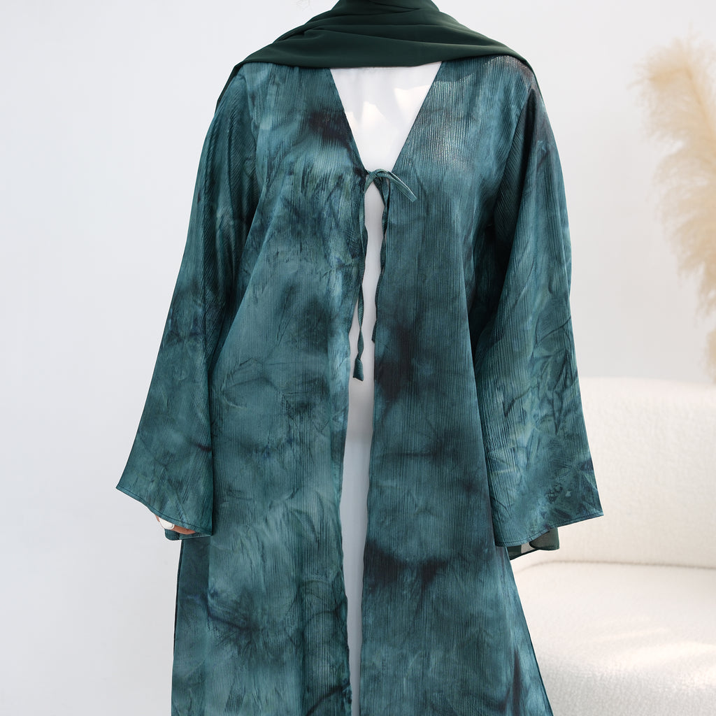 Teal tie-dye dress on a mannequin against a white background