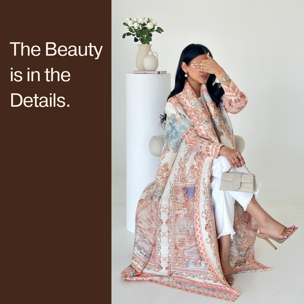 Woman wearing a patterned dress with text 'The Beauty is in the Details' on a brown background