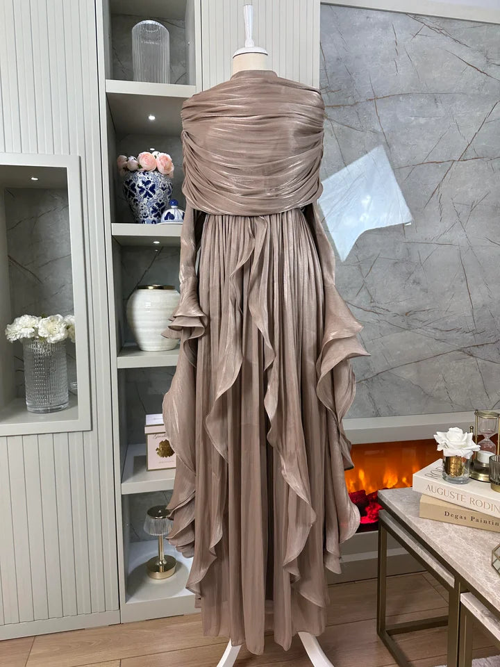 Beige evening gown on a mannequin against a decorative interior background