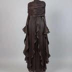 Brown ruffled dress on a mannequin in a room with shelves and decor.